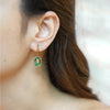 Gold plated Huggies hoop drop earrings featuring a vintage oval green natural stone charm with a gold diamond motif, by eda jewels dubai