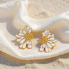 June gold plated daisy earrings with white enamel petals by Eda Jewels Dubai