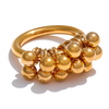 Eda jewels Dubai Gold plated statement ring featuring a chunky band and a cluster of dangling, high shine gold spheres.