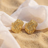Mia large gold plated textured molten wavy stud earrings on sand by Eda Jewels Dubai