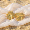 Mila gold plated crinkled geometric statement stud earrings worn by a model by Eda Jewels Dubai