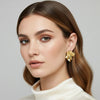 Mila gold plated crinkled geometric statement stud earrings worn by a model by Eda Jewels Dubai