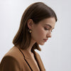 Mira gold plated chunky hoop earrings featuring a central smooth metal sphere charm by Eda Jewels Dubai
