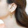 Mira gold plated chunky hoop earrings featuring a central smooth metal sphere charm by Eda Jewels Dubai