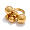 Eda Jewels Dubai Ree Ring, a gold plated statement ring featuring a chunky band and a cluster of polished gold spheres in varying sizes.