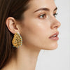 Gold plated spiral Seashell nautila stud earrings featuring a turquoise beaded edge detail worn by a model by Eda Jewels Dubai