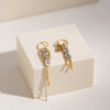 Sia asymmetric gold plated charm hoop earrings with mixed metal silver chains and a rhinestone strand by Eda Jewels Dubai
