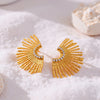 Eda Jewels Dubai gold plated sunburst fan statement stud earrings with brilliant crystal diamond pave accents displayed on white sand