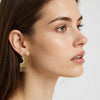 Eda Jewels Dubai gold plated sunburst fan statement stud earrings with brilliant crystal diamond pave accents worn by a model