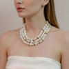 Aria bold multi strand pearl statement necklace featuring alternating gold plated beads worn by a model by Eda Jewels Dubai