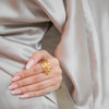 Ash gold plated everyday statement ring featuring a sleek botanical leaf design worn by a model by Eda Jewels Dubai
