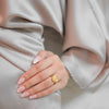 Astra gold plated everyday statement ring featuring celestial moon and star engravings worn by a model by Eda Jewels Dubai