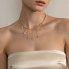 Astris gold plated celestial choker necklace featuring cascading dangling star and crescent moon charms worn by a model by Eda Jewels Dubai