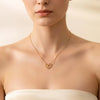 Aurora gold plated minimalist snake chain necklace with an open heart pendant worn by a model by Eda Jewels Dubai