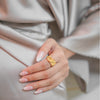 Ayla gold plated everyday statement ring featuring an organic crumpled textured design worn by a model by Eda Jewels Dubai