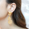 Coraline gold plated coral branch drop earrings by Eda Jewels Dubai. Perfect statement daily wear gifting piece.