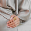 Eva gold plated wide statement ring featuring a spiked sunburst design worn by a model by Eda Jewels Dubai