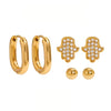 Gold plated Hamsa earring set by Eda Jewels Dubai, featuring oval hoops, crystal-embellished Hamsa studs, and minimalist ball studs