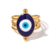 Kaya gold plated statement everyday ring featuring a large oval evil eye talisman with deep blue, white, and light blue enamel on a triple-band setting by Eda Jewels Dubai