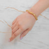Noa gold plated organic molten cuff stacking bangle. Perfect statement daily wear piece by Eda Jewels Dubai.