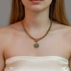 Oria gold plated chunky link chain necklace featuring a sunburst pendant with a turquoise stone center worn by a model by Eda Jewels Dubai