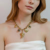 Siddhi gold plated chunky link charm necklace featuring a statement elephant head, heart, and unique hanging charms worn by a model by Eda Jewels Dubai