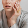 Talia gold plated oversized statement ring featuring a textured starfish design worn by a model by Eda Jewels Dubai