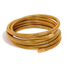 Veya gold plated coiled gaspipe wrap bracelet by Eda Jewels Dubai. Perfect statement daily wear gifting piece.